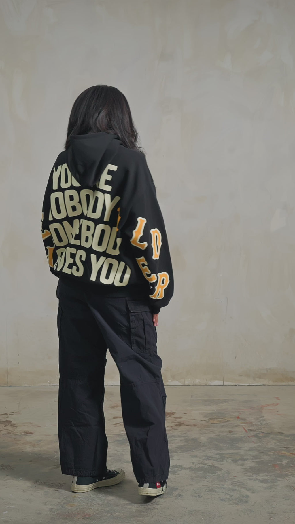 Black Somebody Hoodie — studio fit video, back, turning