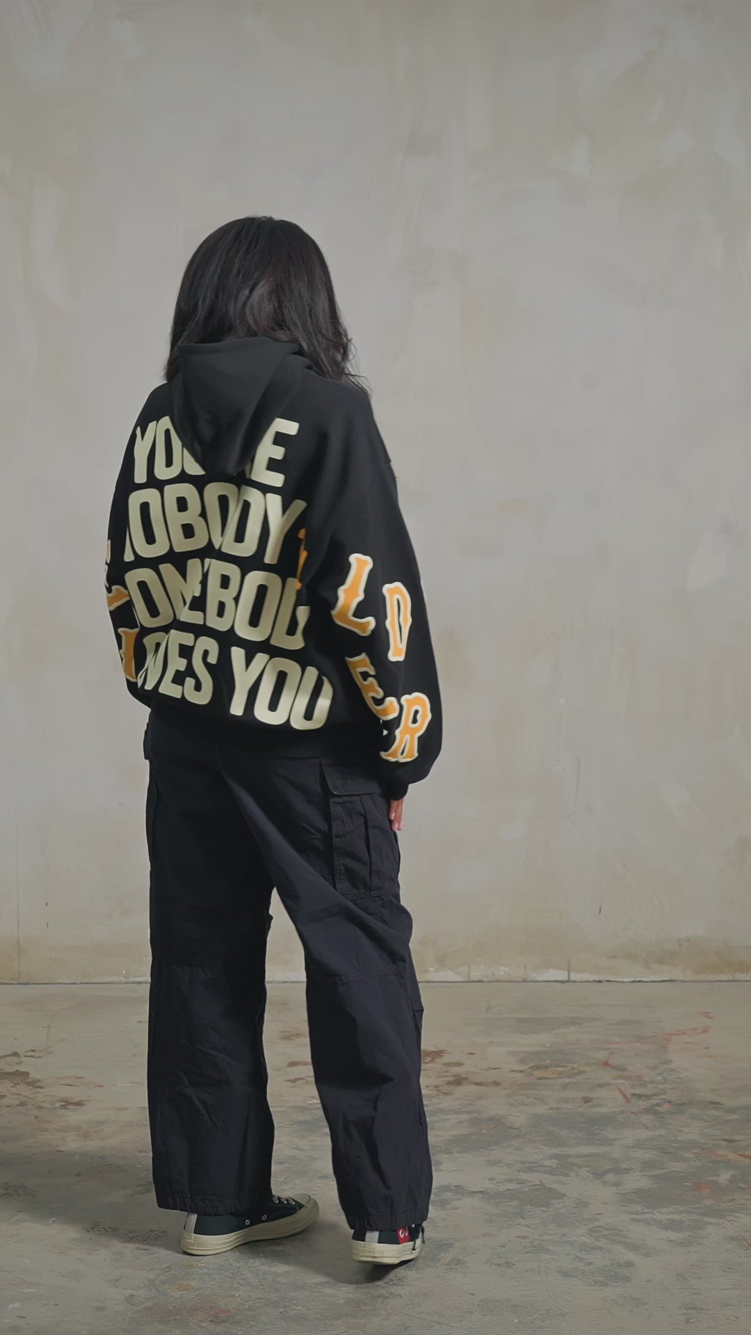Black Somebody Hoodie — studio fit video, back, turning