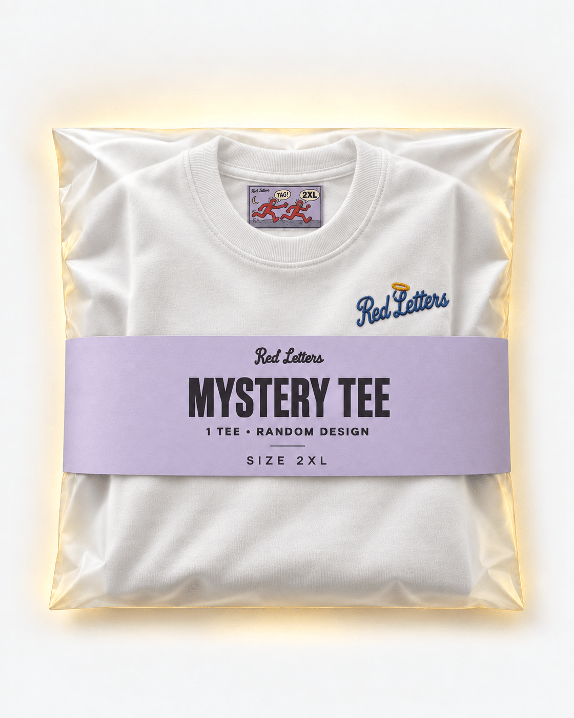 Red Letters Mystery Tee, size 2XL, with a stitched illustrated neck tag, subtle embroidered chest logo and lilac packaging. One tee, random design.