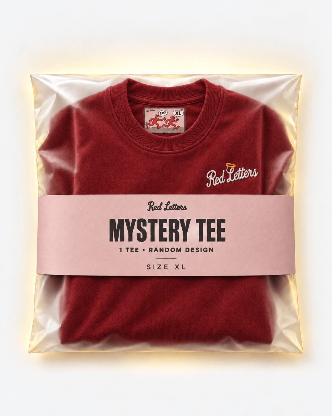 Red Letters Mystery Tee, size XL, with a stitched illustrated neck tag, subtle embroidered chest logo and rose packaging. One tee, random design.