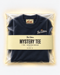 Red Letters Mystery Tee, size S, with a stitched illustrated neck tag, subtle embroidered chest logo and butter packaging. One tee, random design.