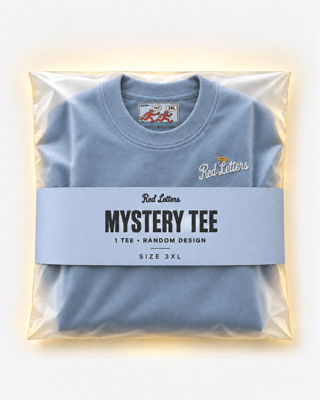 Red Letters Mystery Tee, size 3XL, with a stitched illustrated neck tag, subtle embroidered chest logo and periwinkle packaging. One tee, random design.