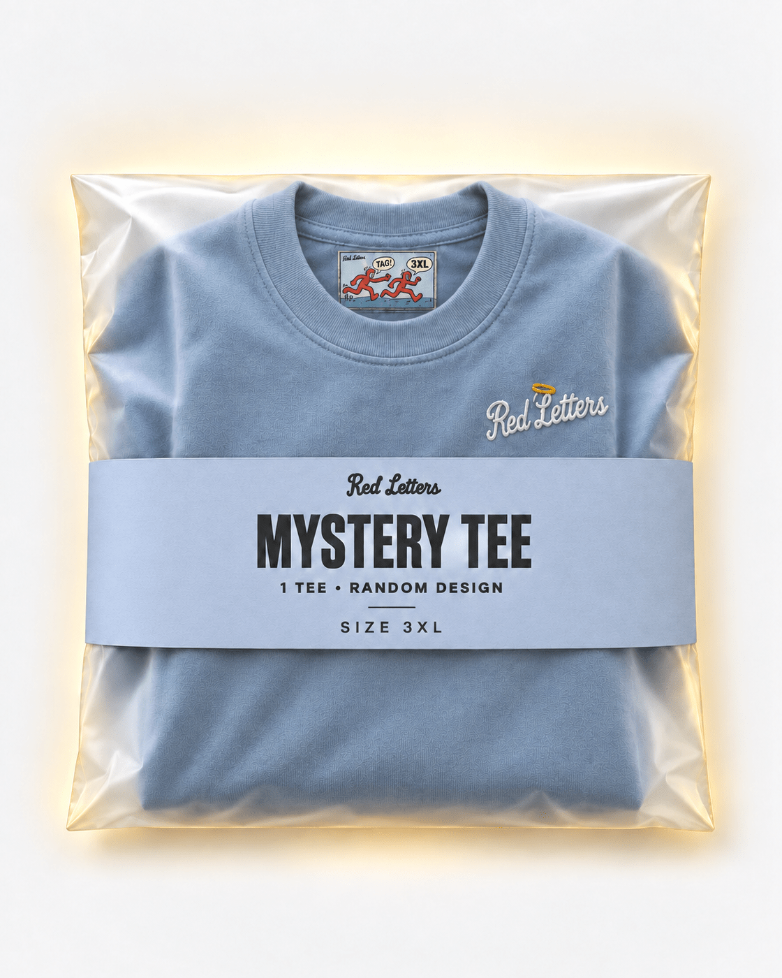 Red Letters Mystery Tee, size 3XL, with a stitched illustrated neck tag, subtle embroidered chest logo and periwinkle packaging. One tee, random design.